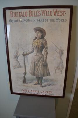 LOT 661.  FRAMED ANNIE OAKLEY POSTER.