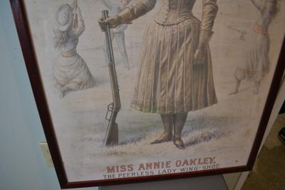 LOT 661.  FRAMED ANNIE OAKLEY POSTER.