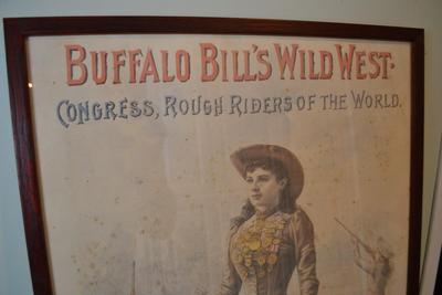 LOT 661.  FRAMED ANNIE OAKLEY POSTER.