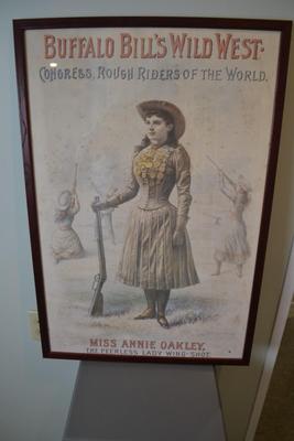 LOT 661.  FRAMED ANNIE OAKLEY POSTER.