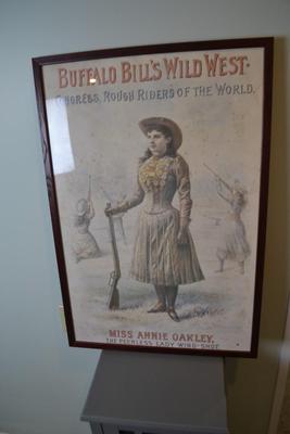LOT 661.  FRAMED ANNIE OAKLEY POSTER.