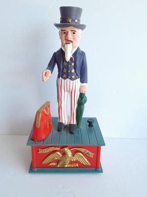 Uncle Sam coin bank and wooden coin bank with movement