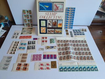 Unused postage stamp collection with Color Treasury of Stamp Collecting book.