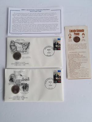 Two unopened 2004 United States Louisianna Purchase Five-Cent coins and a Lincoln - Kennedy Penny
