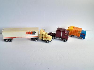 Two Semi Trucks one with trailer Road Champs, and Hot Wheels, and Matchbox Refuse Truck