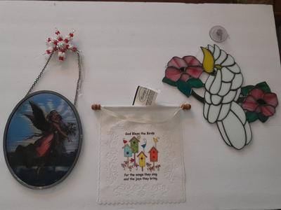 Stained glass window hangings and a small God bless the birds Tapestry.
