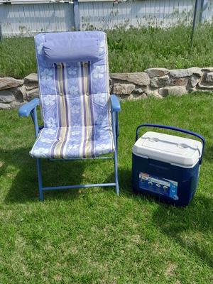 Folding metal framed folding chair with cushioned fabric and a 28 quart cooler
