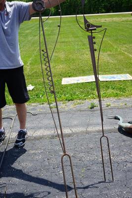 YARD ART. PAIR POLE SCULPTURES WITH ABSTRACT FINIALS. 5FT