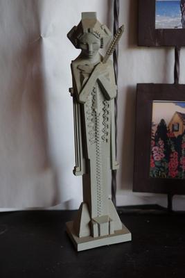 INTHE PRAIRIE STYLE. TWO FRAMED PAPER PRINTS IN BLACK FRAMES WITH WROUGHT IRON HANGER. FLW STYLE STATURE OF 8" & CLOCK FROM THE...