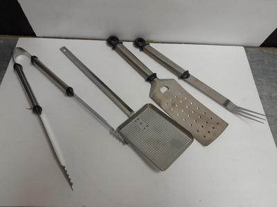 Large stainless steel cooking utensils Barbeque grill or firepit and condiment containers