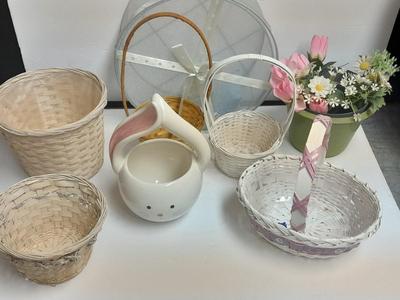 assortment of baskets, pots, bunny statues and faux flowers.