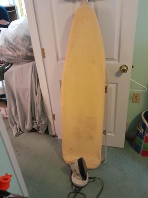 Ironing board with a Westbend power ease cordless Iron and power base charger