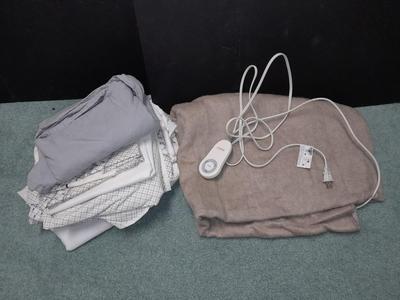 Two Queen sized sheet sets and a heated throw blanket