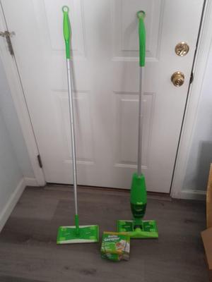 Two Swiffer mops and Swiffer pads