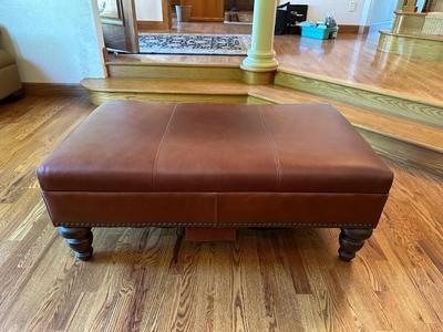 LEATHER OTTOMAN WITH NAILHEAD ACCENTS