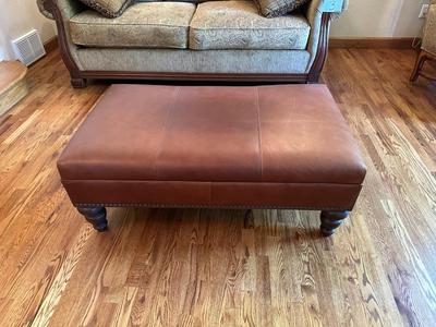 LEATHER OTTOMAN WITH NAILHEAD ACCENTS