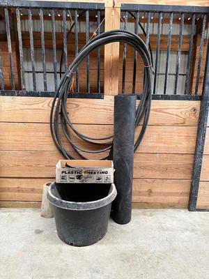GARDEN HOSE, WEED BARRIER, PLASTIC SHEETING AND A LARGE FLOWER POT