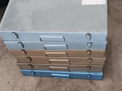Six metal slide boxes full of slides from various travels