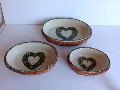 Three heart design nesting bowls each with its own basket.  Heavy ceramic
