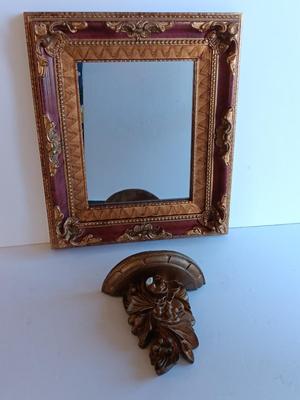 Gold and maroon decorative framed wall mirror with small shelf