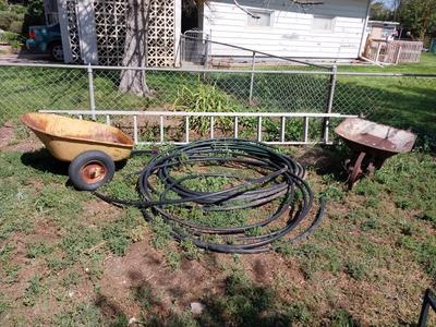 EXTENSION LADDER, TRAILER, TUBING AND OLD WHEELBARROW