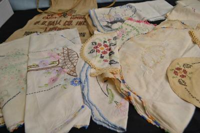 LOT 55. LUMBER YARD APRON AND EMBROIDERED VINTAGE LINENS