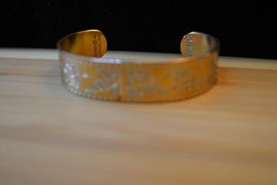 LOT 87 DISNEY COPPER BRACELET AND CHURCHILL BOOK MARK