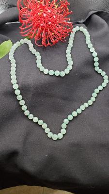 Pale green jade necklace hand tied with green cording