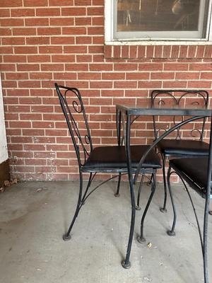 IRON FRAMED PATIO TABLE WITH GLASS TOP AND 4 IRON CHAIRS