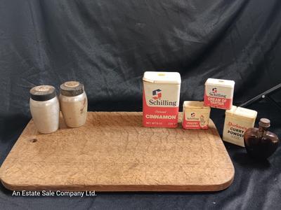 Primitive wooden cutting board with tin spice containers and aluminum salt & pepper shakers