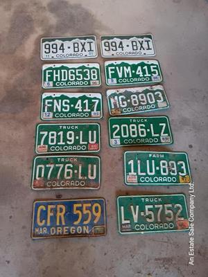 Newer Colorado License plates with annual stickers and one Oregon plate