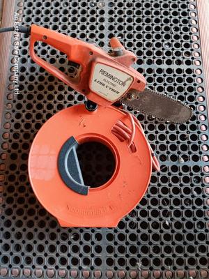 Small Remington Electric Limb n' Trim 8" chain saw with extension cord in cord spool