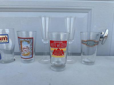 AN ASSORTMENT OF BEER GLASSES FROM VARIOUS BREWERIES