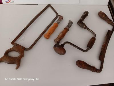 Variety of vintage hand tools - wooden handles - saw - drill - draw knife