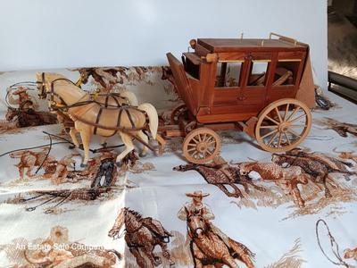 Vintage wooden covered wagon with horse team and wild west cowboy fabric