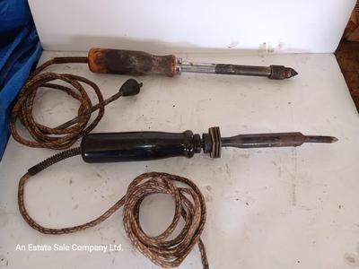 Two antique electric soldering irons with different sized heads