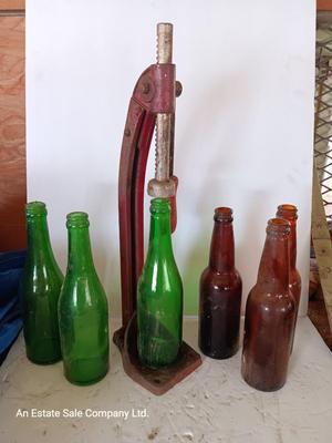 Vintage bottle cork machine hand crank with vintage glass bottles