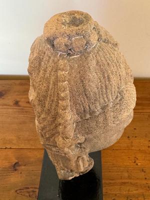 Sandstone Buddha head on pedestal, India, c. 16th-17th Century