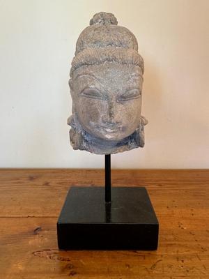 Sandstone Buddha head on pedestal, India, c. 16th-17th Century