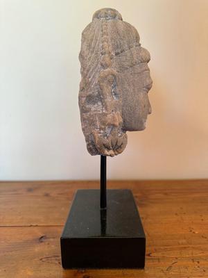 Sandstone Buddha head on pedestal, India, c. 16th-17th Century