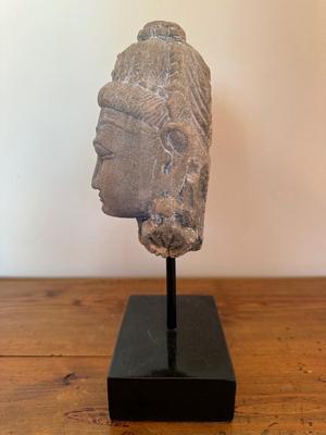 Sandstone Buddha head on pedestal, India, c. 16th-17th Century