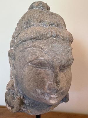 Sandstone Buddha head on pedestal, India, c. 16th-17th Century