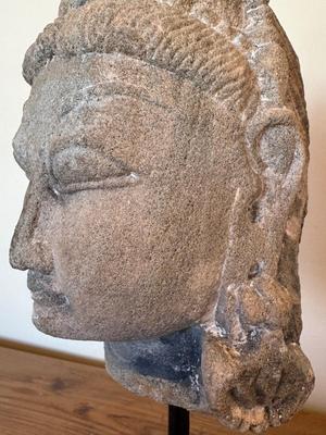 Sandstone Buddha head on pedestal, India, c. 16th-17th Century