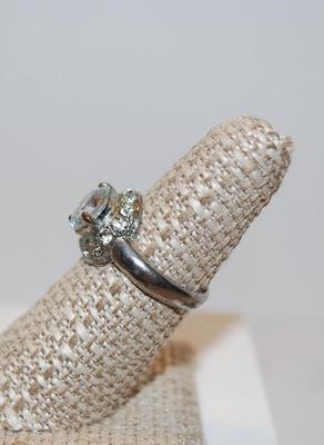 3 Prong Clear Faceted Stone with 14 Stones in a Neck-Wrap Style Surround Size 7 1/4