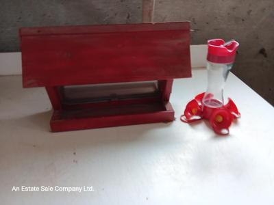 Wooden handmade bird feeder and a Glass globed hummingbird feeder.