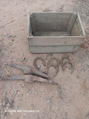 Wooden crate box with horseshoes and pickaxe heads