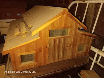 Wooden hand-crafted barn with lights inside Horse stables