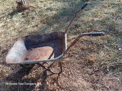 Old wheelbarrow for flowerbed of yard art
