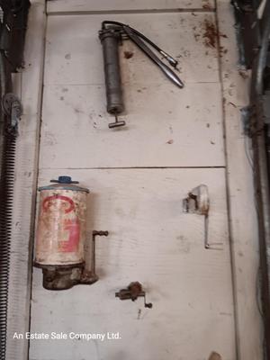 Antique can opener - hand cleaner dispenser - and pencil sharpener with a grease gun