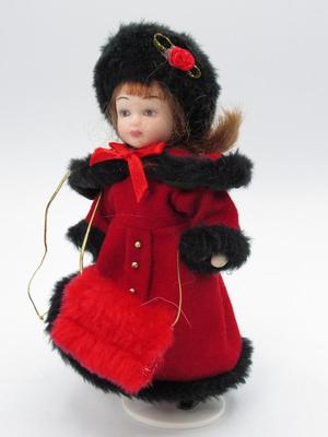 Small Porcelain Figurine in Red Winter Coat Jacket with Display Stand